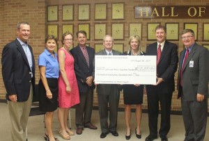 With the ceremonial $125,000 check from the Otto Bremer Foundation are (from left): Central High Principal Jeff Fleig; Dyanne Brudos, Bremer Bank; Heather Quackenboss, La Crosse Community Foundation; Mark Carpenter, Bremer Bank; Dale Walter, president of Bremer Bank La Crosse; Logan Principal Deb Markos; La Crosse Public Education Foundation Executive Director David Stoeffler; Superintendent of Schools Randy Nelson.