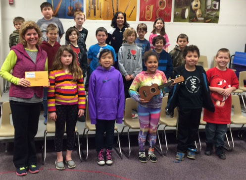 Amy Johnson-Pierce, front left, gathers with one of her music classes at Spence Elementary to celebrate the Uke for Youth grant. The project will help buy a set of ukuleles to be shared among all La Crosse public elementary schools.